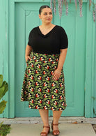 size 18 model wearing black retro style cotton skirt with wide waist band and pockets