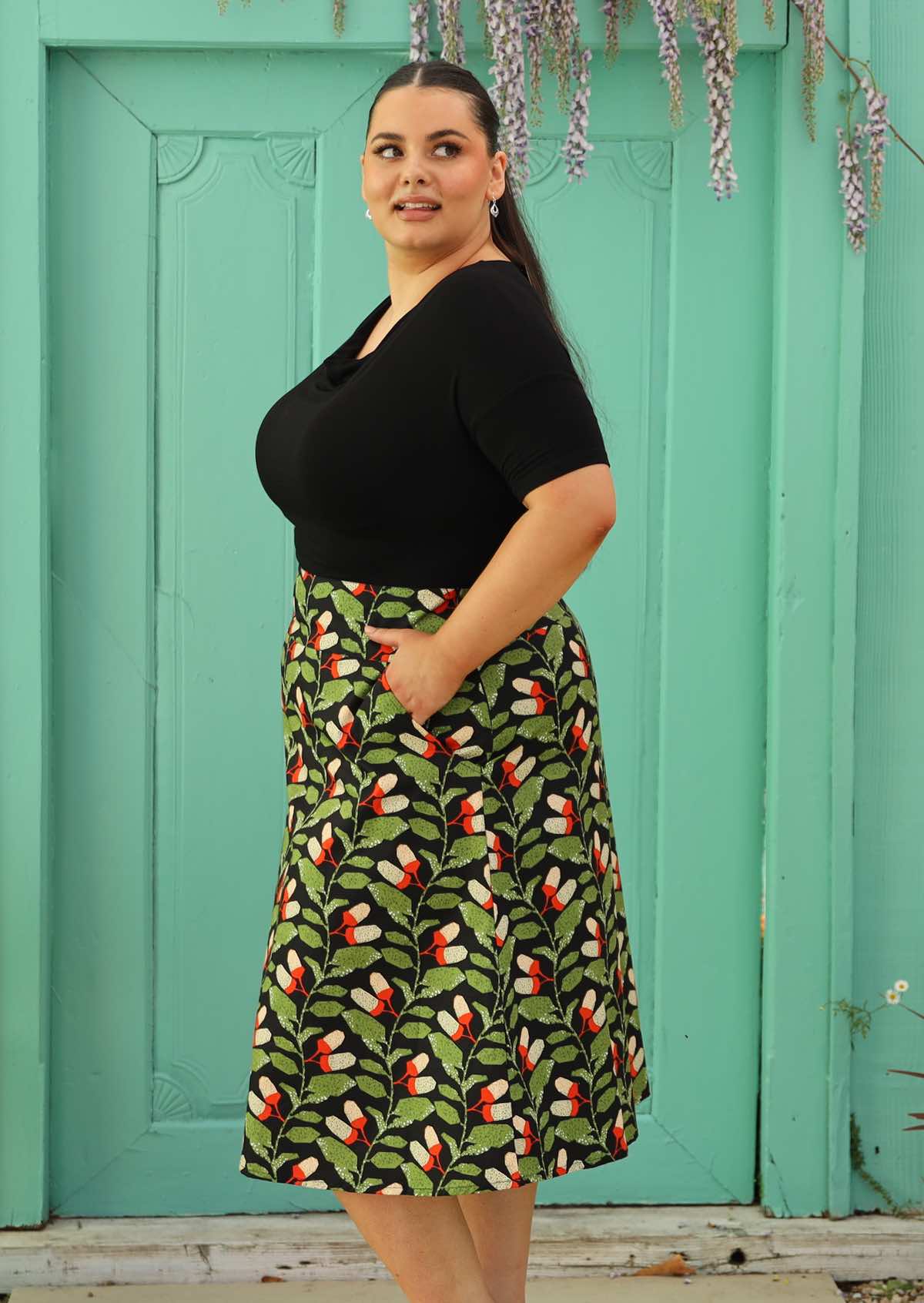 size 18 model wearing black retro style cotton skirt with pockets
