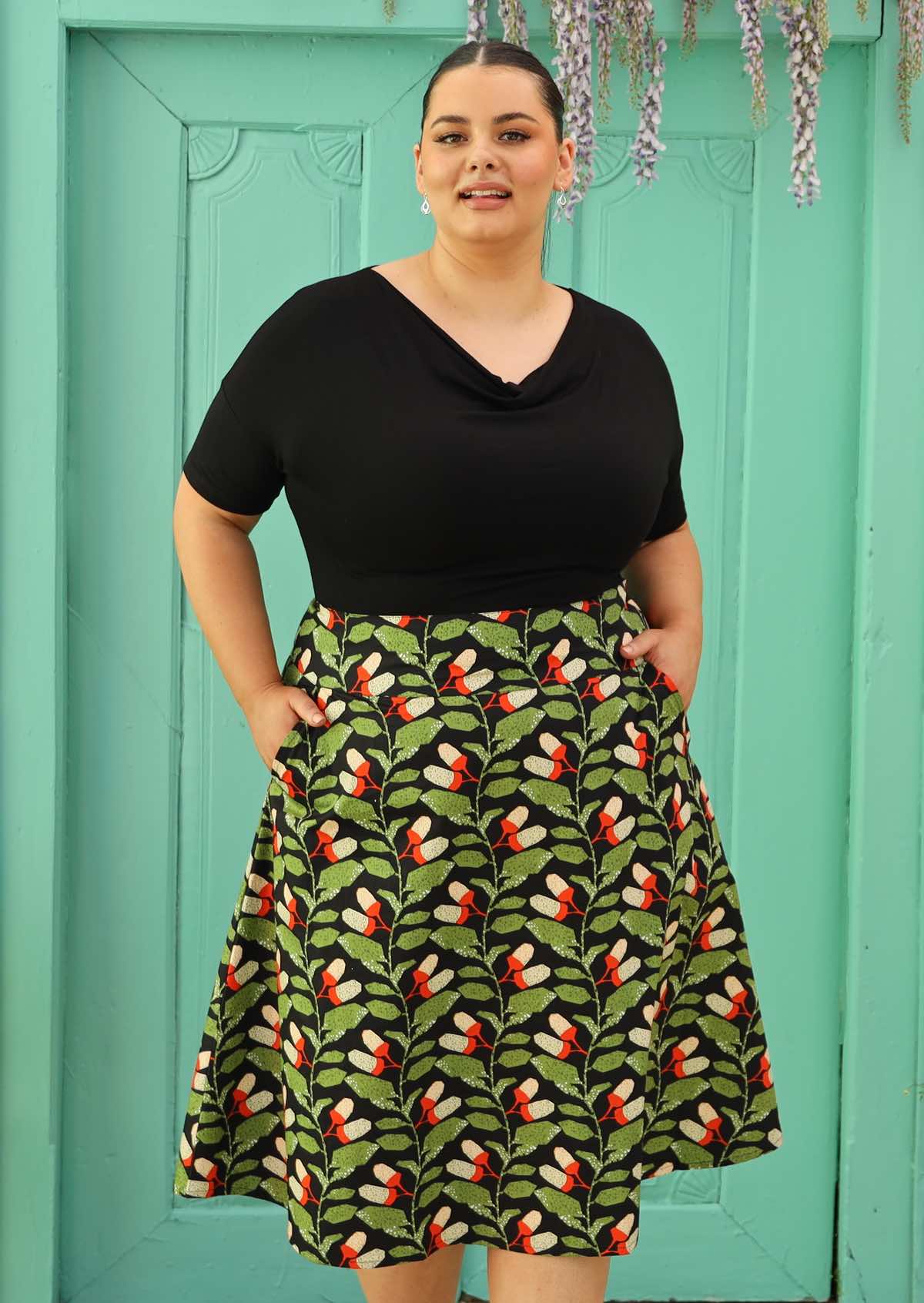 Plus size model wearing black retro style cotton skirt with wide waist band and pockets