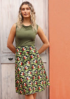 Model wears Zarah Skirt Oak green, orange and white speckled botanical print on a black base cotton, generous A-line skirt with wide yoke and pockets and a hidden side zip | Karma East Australia