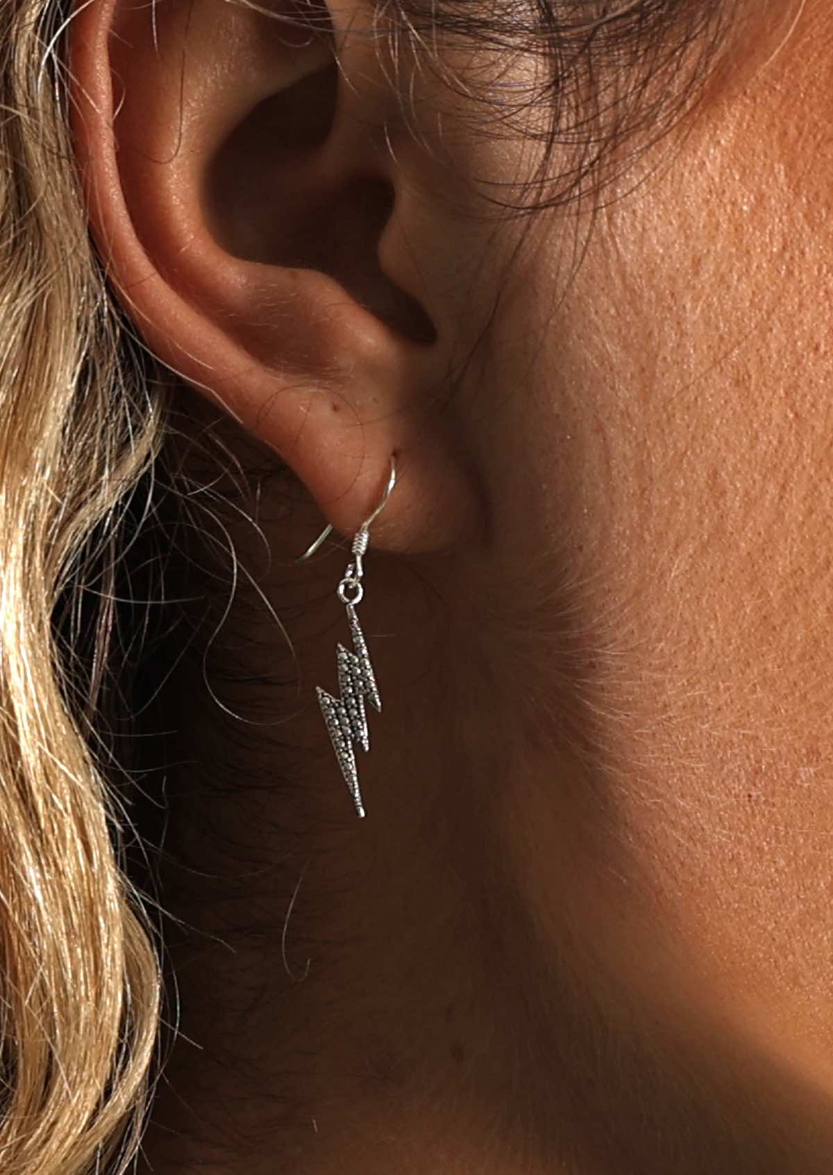 Lightning Bolt Dangly Silver Earrings on woman