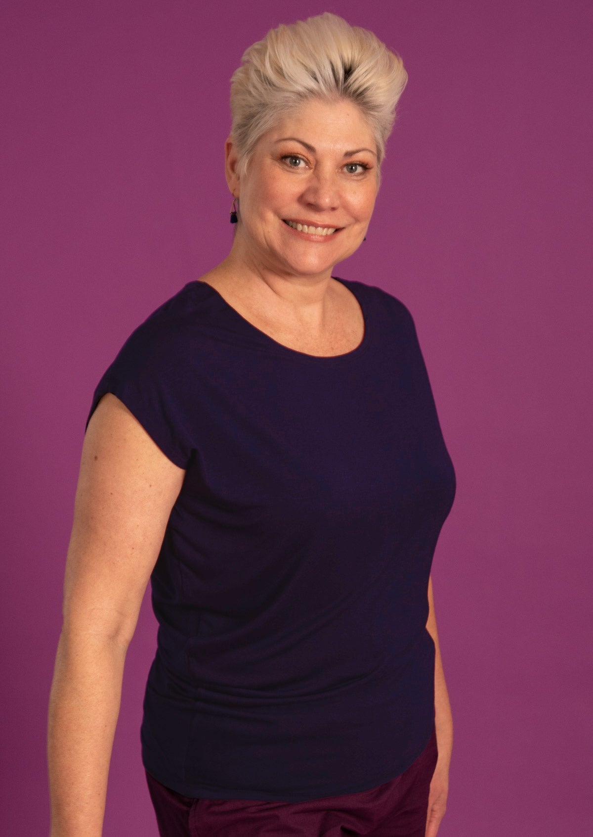 Woman wearing round neckline asymmetrical navy top