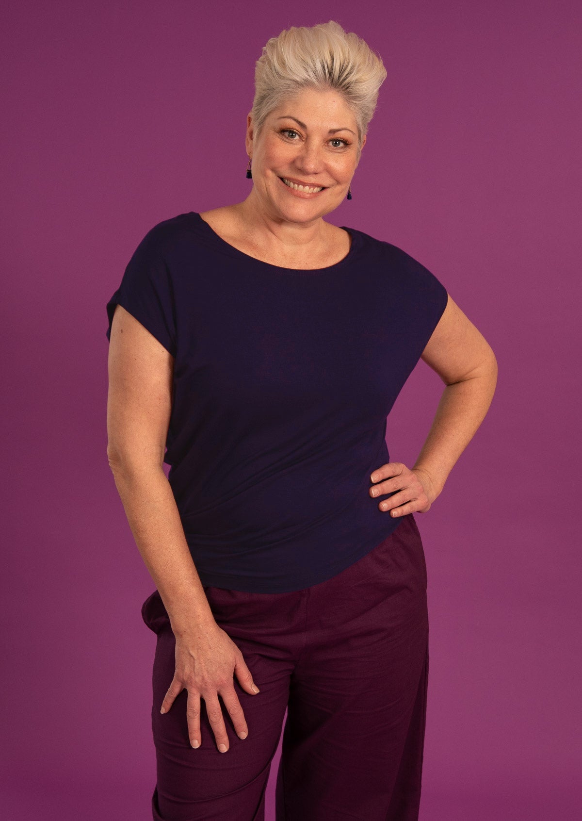 Woman wearing asymmetrical navy blue rayon top 