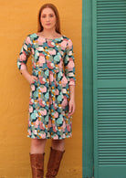 Women wears cotton dress with small gathers in relaxed waistline, 3/4 sleeves and pockets