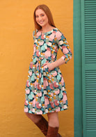 Woman wears relaxed fit 100% cotton women's dress in beautiful pastel spotted print.