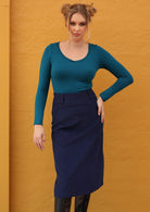 Model wears blue mid length cotton corduroy skirt