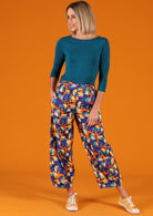 Greta Pants high waisted women's pants elasticated waistband side pockets pleats at side of ankles 100% cotton blue orange yellow house print | Karma East Australia