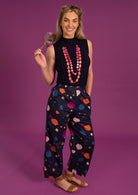 Greta Pants high waisted women's pants elasticated waistband side pockets pleats at side of ankles 100% cotton dark navy background coloured spot print| Karma East Australia