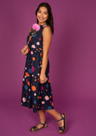Below the Knee Length, sleeveless dress with tiers and pockets.