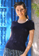 Woman with dark hair wearing a scoop neck navy blue rayon fitted t-shirt.