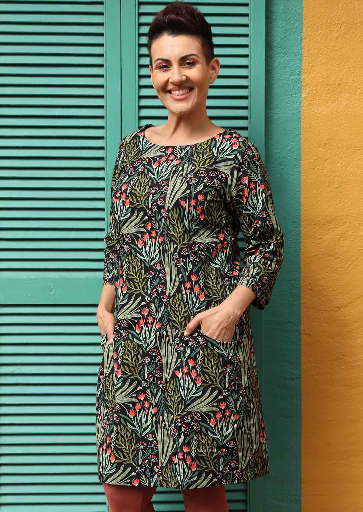 Jamie Dress round neck 3/4 sleeve cuff detail fitted bodice a-line skirt pockets knee length 100% cotton black background green and pink peach floral print | Karma East Australia
