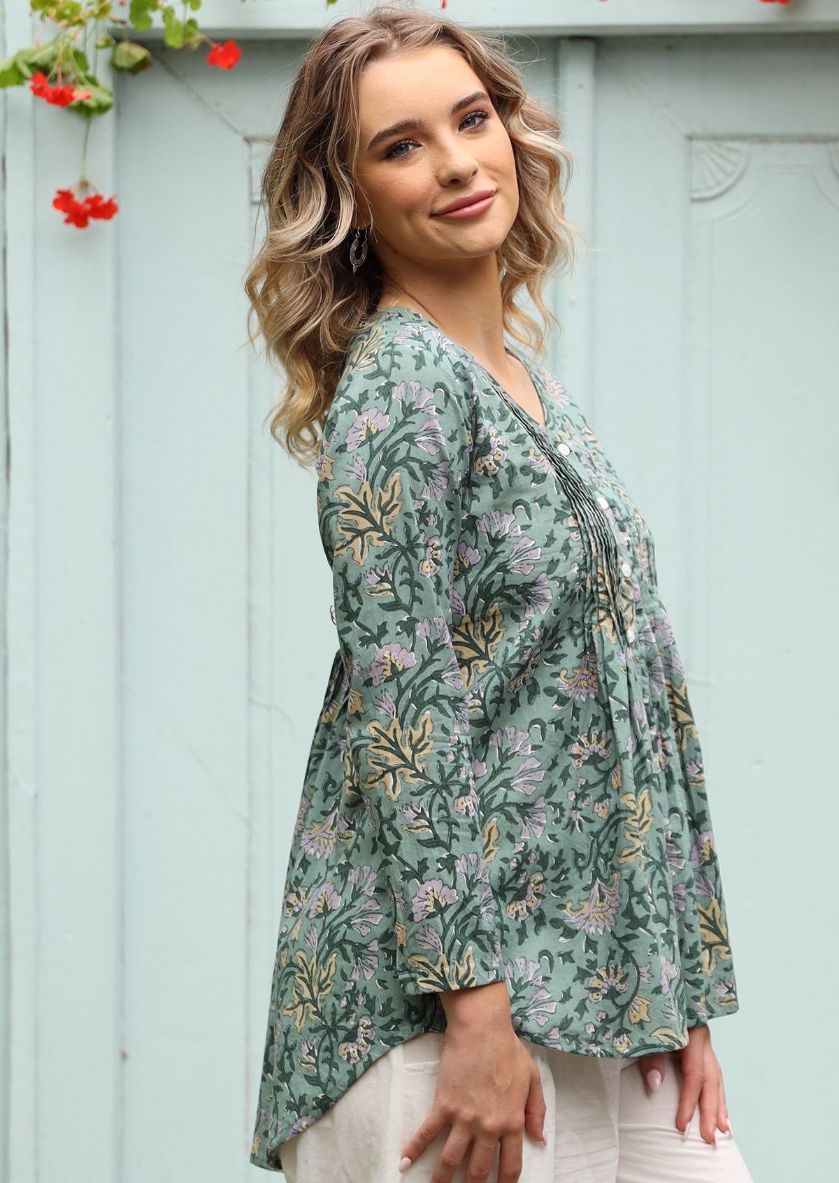 Loose fitted long sleeve women's cotton blouse which is longer at the back.