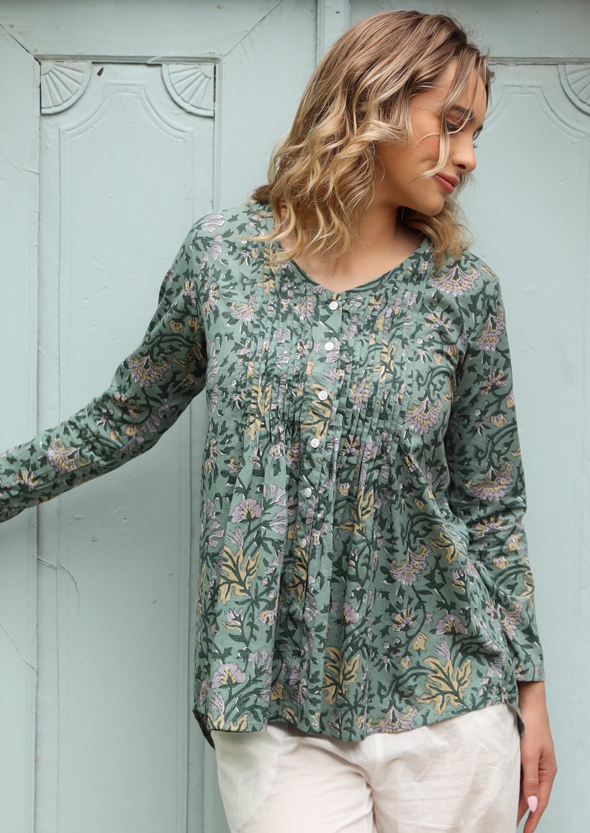 pleated front and back detail full sleeve top with V neckline and A line shape.