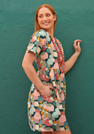 Side pockets women's 100% cotton dress with short sleeves and delicate pin tucks at the loose waist.
