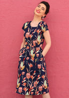 Retro Inspired Womens Cotton Dress navy background pink and green toned floral print tailored bodice short sleeve waistband leading into an a-line skirt below the knee with pockets
