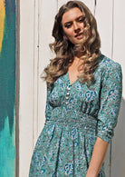Woman wears gorgeous rayon maxi dress with elasticated waist, V neckline and 3/4 sleeves